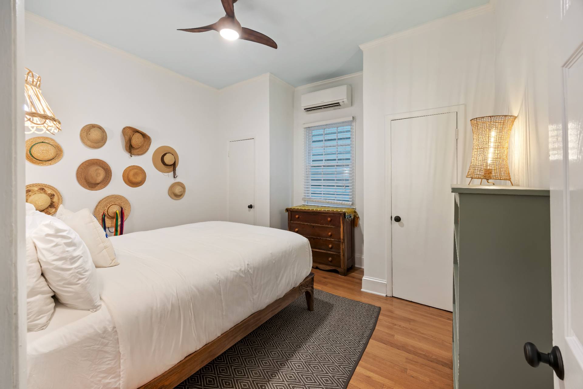 Suite A queen bedroom with straw hat gallery wall